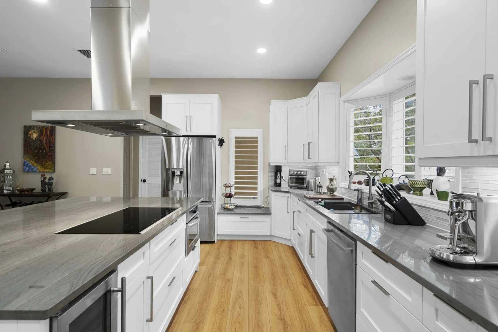 Award-winning kitchen remodel by Premiere Builders with white shaker cabinets and quartz counters